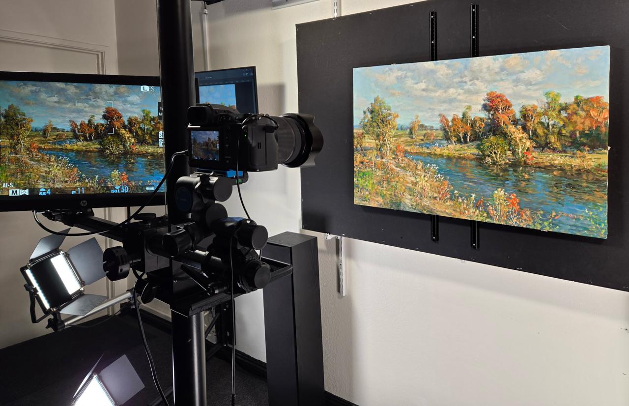 Camera with LED lighting capturing painting on wall