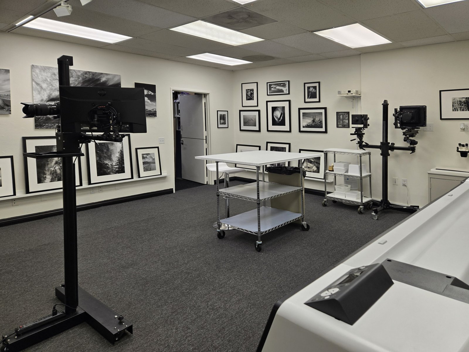 Main studio space with large-format camera and gallery walls at Reflective Image Studios